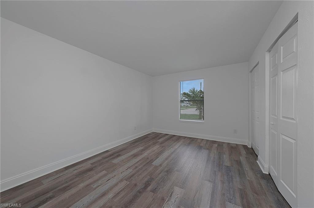 19133 Tangerine Road Fort Myers, FL 33967 - Photo 7 of 17 Unfurnished bedroom featuring a closet and hardwood / wood-style flooring