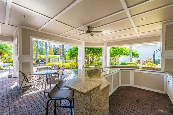a kitchen with sink and view of living room