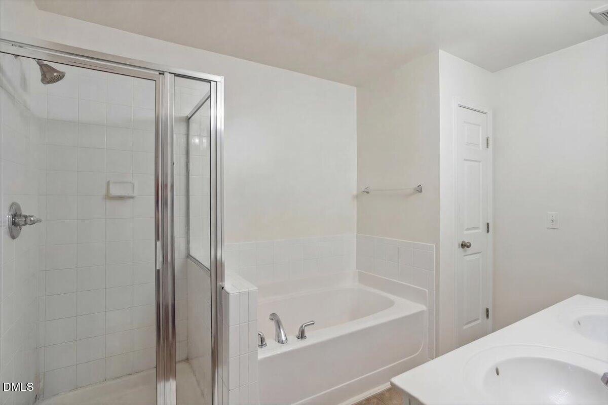 2231 Raven Road, Unit 103 Raleigh, NC 27614 - Photo 24 of 26 a bathroom with a bathtub and a shower