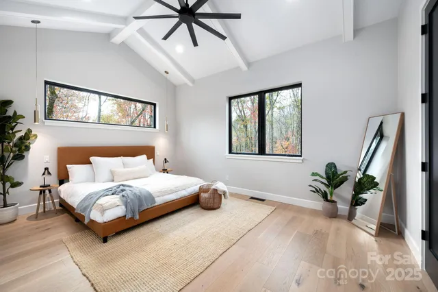 a bedroom with a large bed and a window