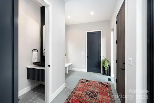a view of a bedroom with wooden floor & ceiling fan