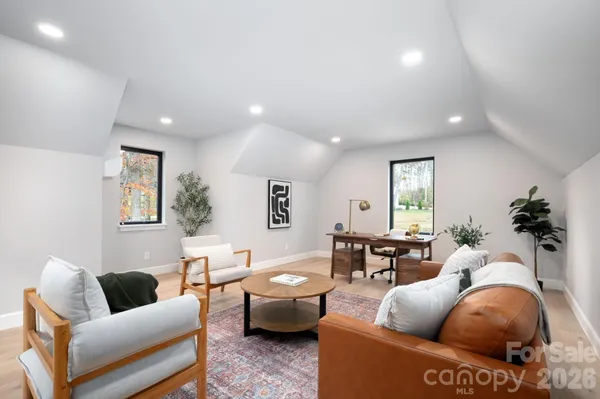 a living room with furniture a rug and a window