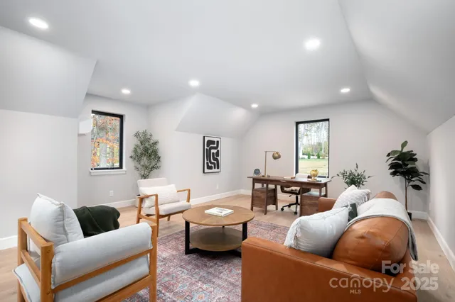 a living room with furniture a rug and a window