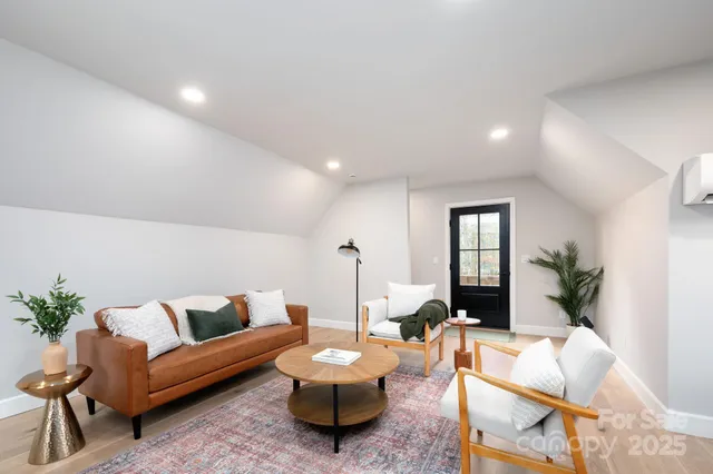 a living room with furniture and a potted plant