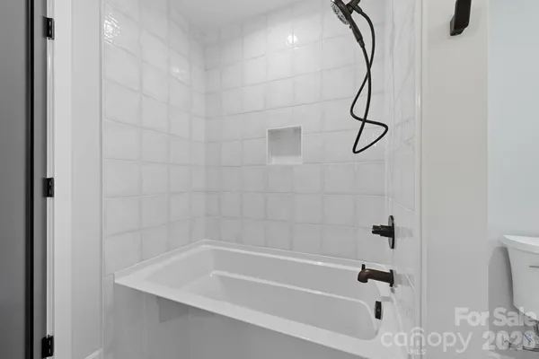 a bathroom with a bath tub with a shower