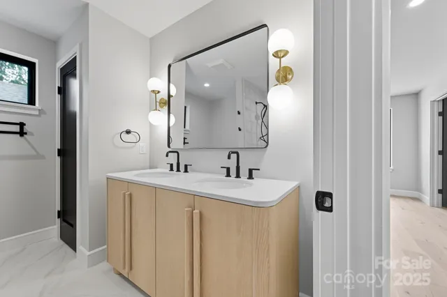 a bathroom with a sink vanity and a mirror