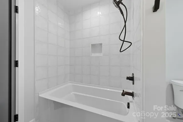 a bathroom with a bath tub with a shower
