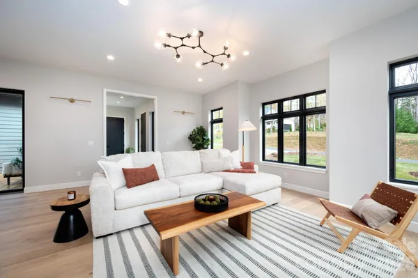 a living room with furniture and wooden floor