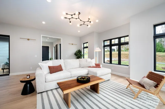 a living room with furniture and wooden floor