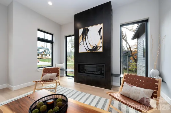 a living room with furniture a window and a fireplace
