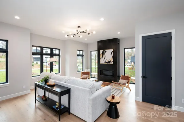 a living room with furniture a window and a chandelier