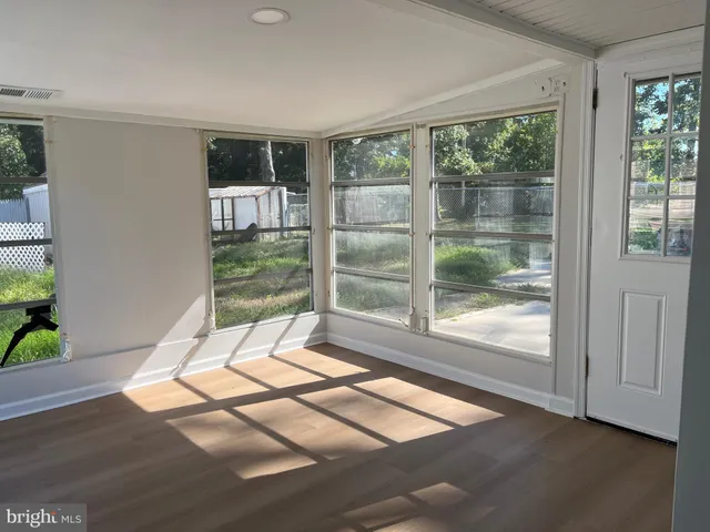 a living room with a large window and outer view