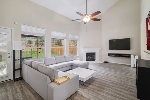 a living room with furniture a fireplace and a flat screen tv