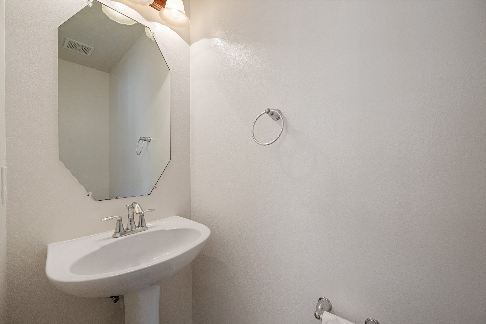 11938 Ramla Place Trail Houston, TX 77089 - Photo 15 of 28 This stylish half bath on the first floor offers modern convenience and a sleek, clean design perfect for guests.
