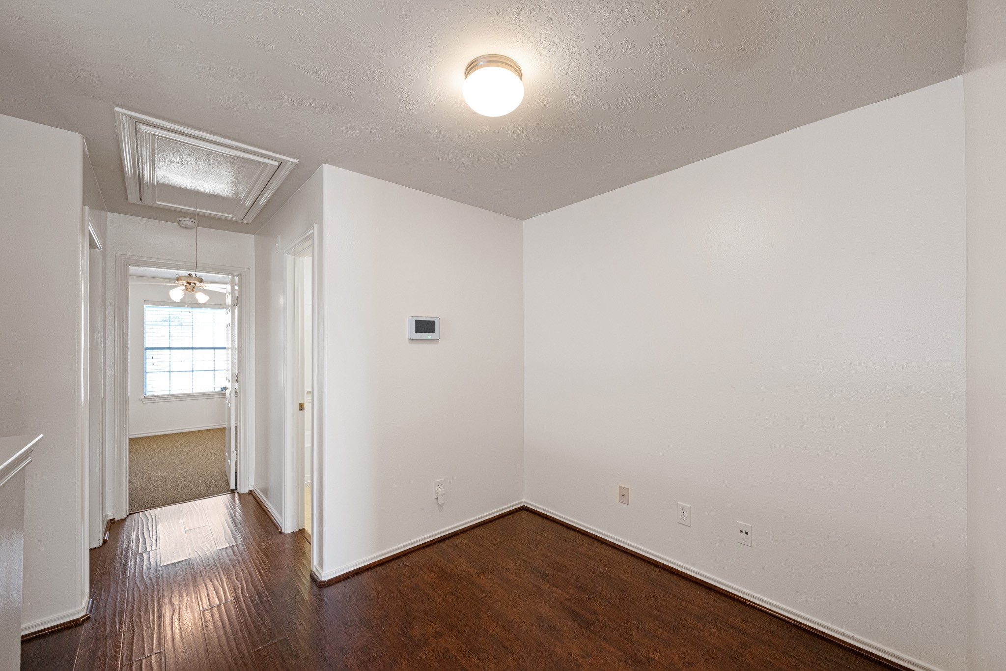 11938 Ramla Place Trail Houston, TX 77089 - Photo 16 of 28 Experience a versatile and inviting second-floor landing area, perfect for creating a cozy reading nook or functional workspace with its warm wood flooring and abundant natural light.