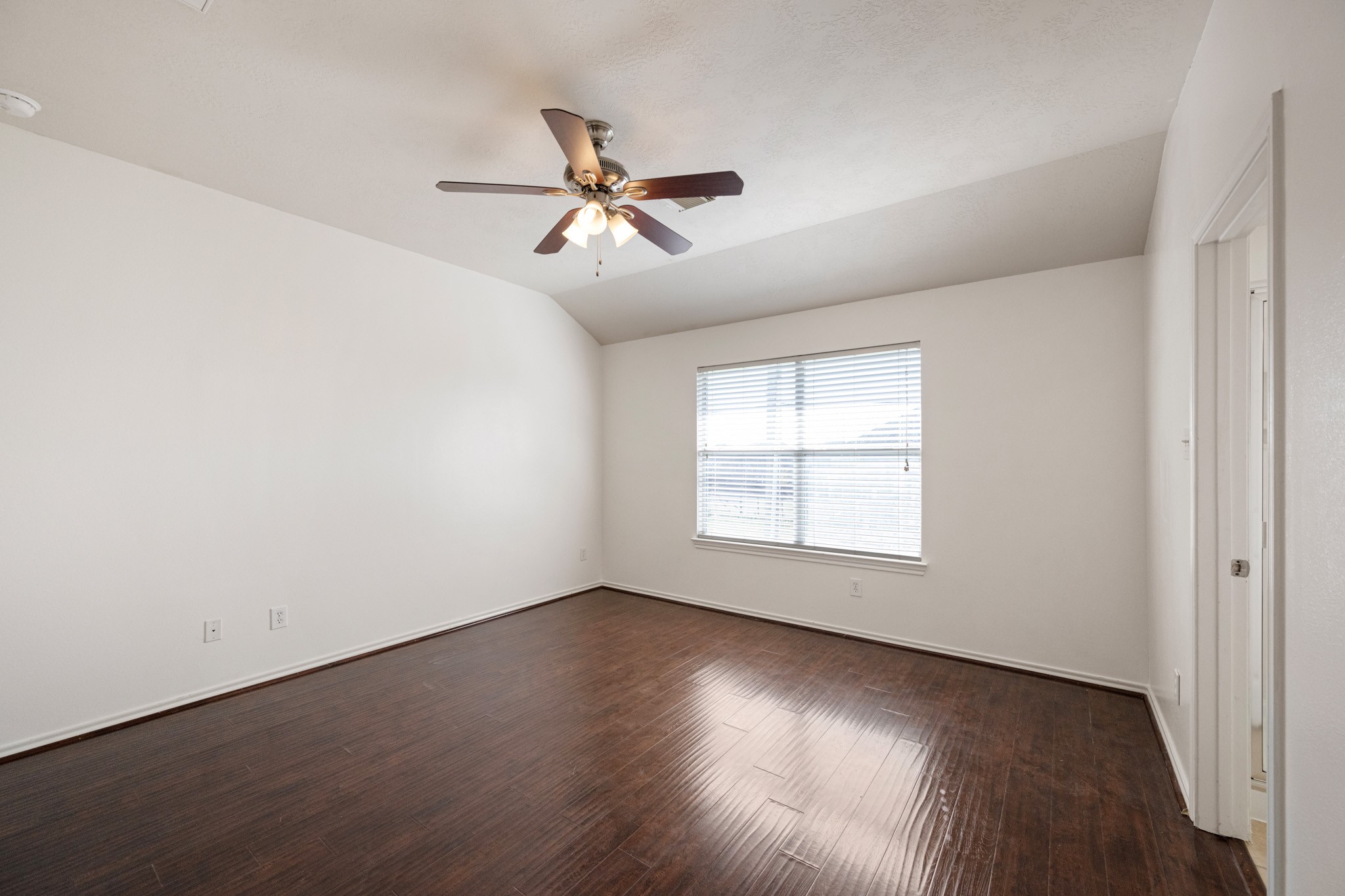 11938 Ramla Place Trail Houston, TX 77089 - Photo 17 of 28 This inviting primary bedroom features elegant flooring, abundant natural light, and a stylish ceiling fan, creating a serene retreat.