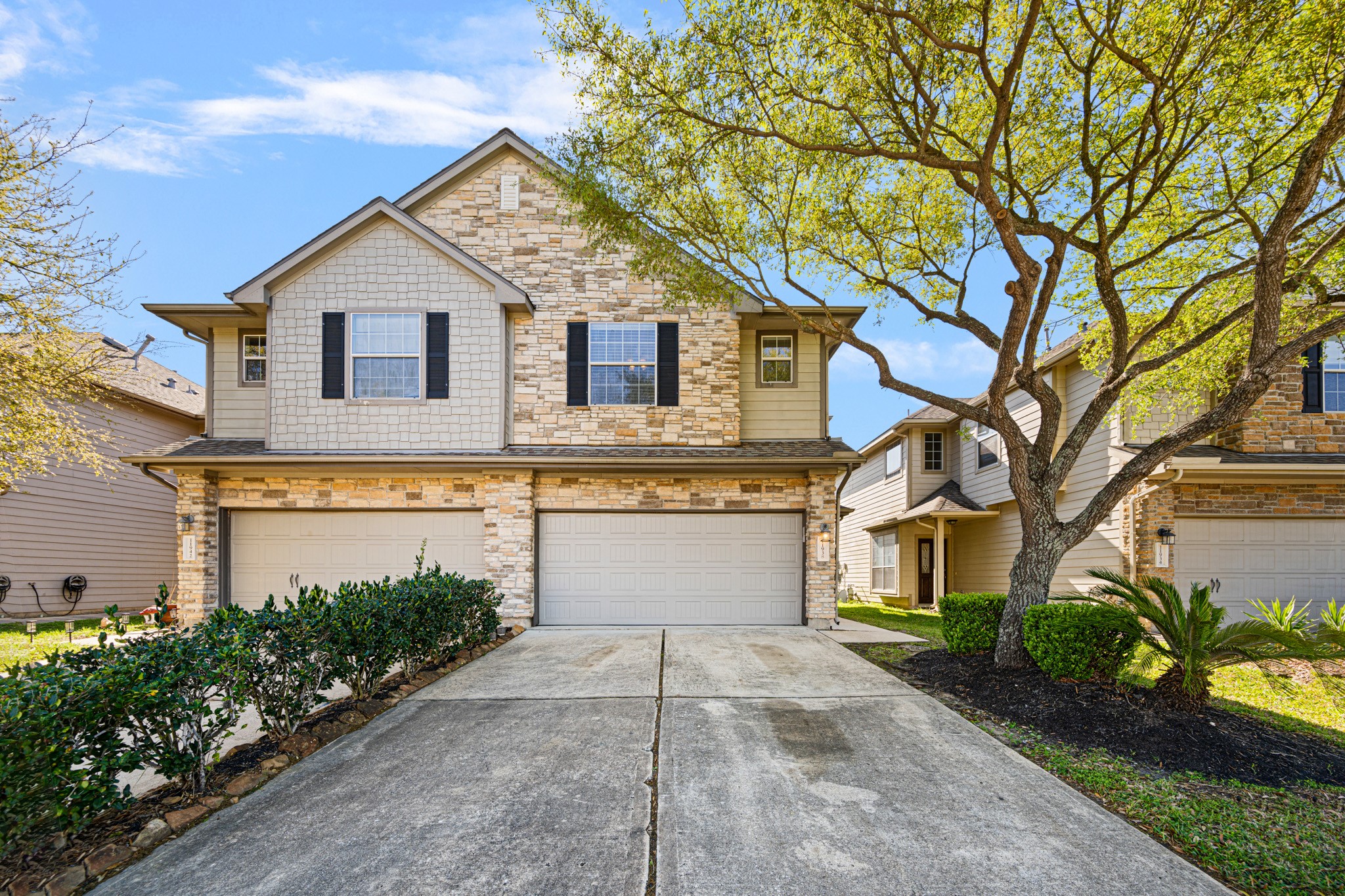 11938 Ramla Place Trail Houston, TX 77089 - Photo 2 of 28 Welcome to your new home: a charming, stone-accented facade with mature trees, inviting driveway, and lush landscaping that offers a warm embrace.
