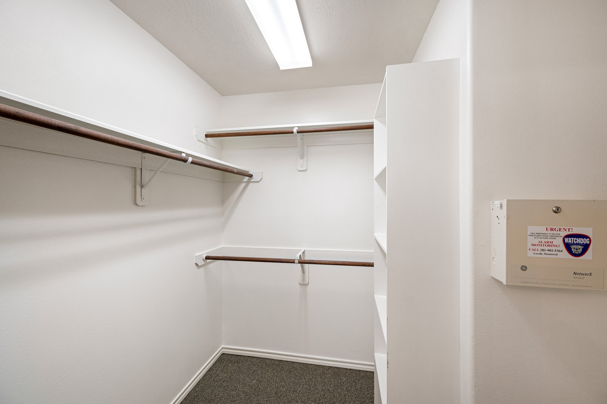 11938 Ramla Place Trail Houston, TX 77089 - Photo 21 of 28 This spacious primary closet offers ample hanging space and built-in shelving, perfect for organizing your wardrobe in style.