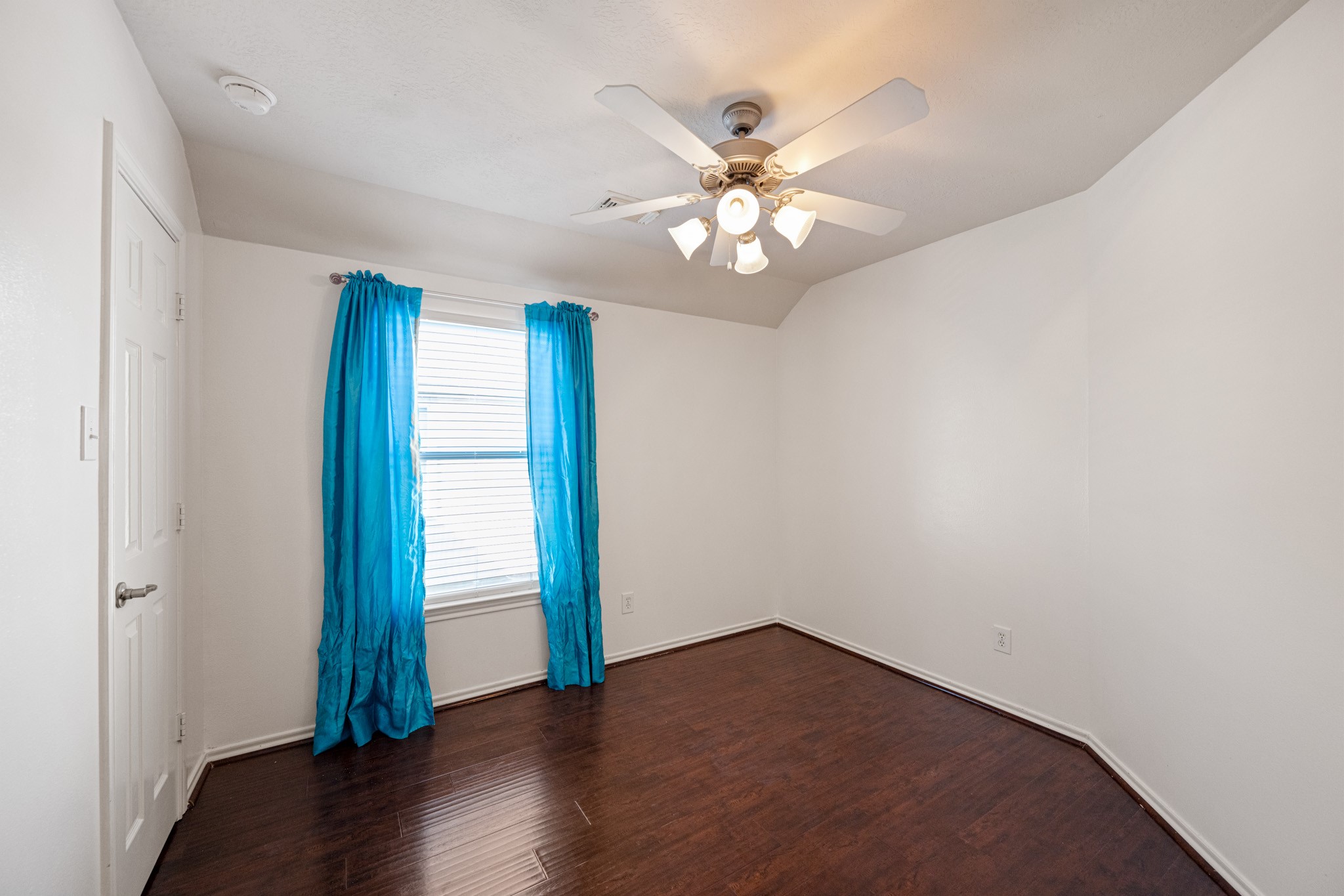 11938 Ramla Place Trail Houston, TX 77089 - Photo 23 of 28 Discover the charm of Bedroom 2, featuring rich hardwood floors, a bright window and a ceiling fan for comfort.