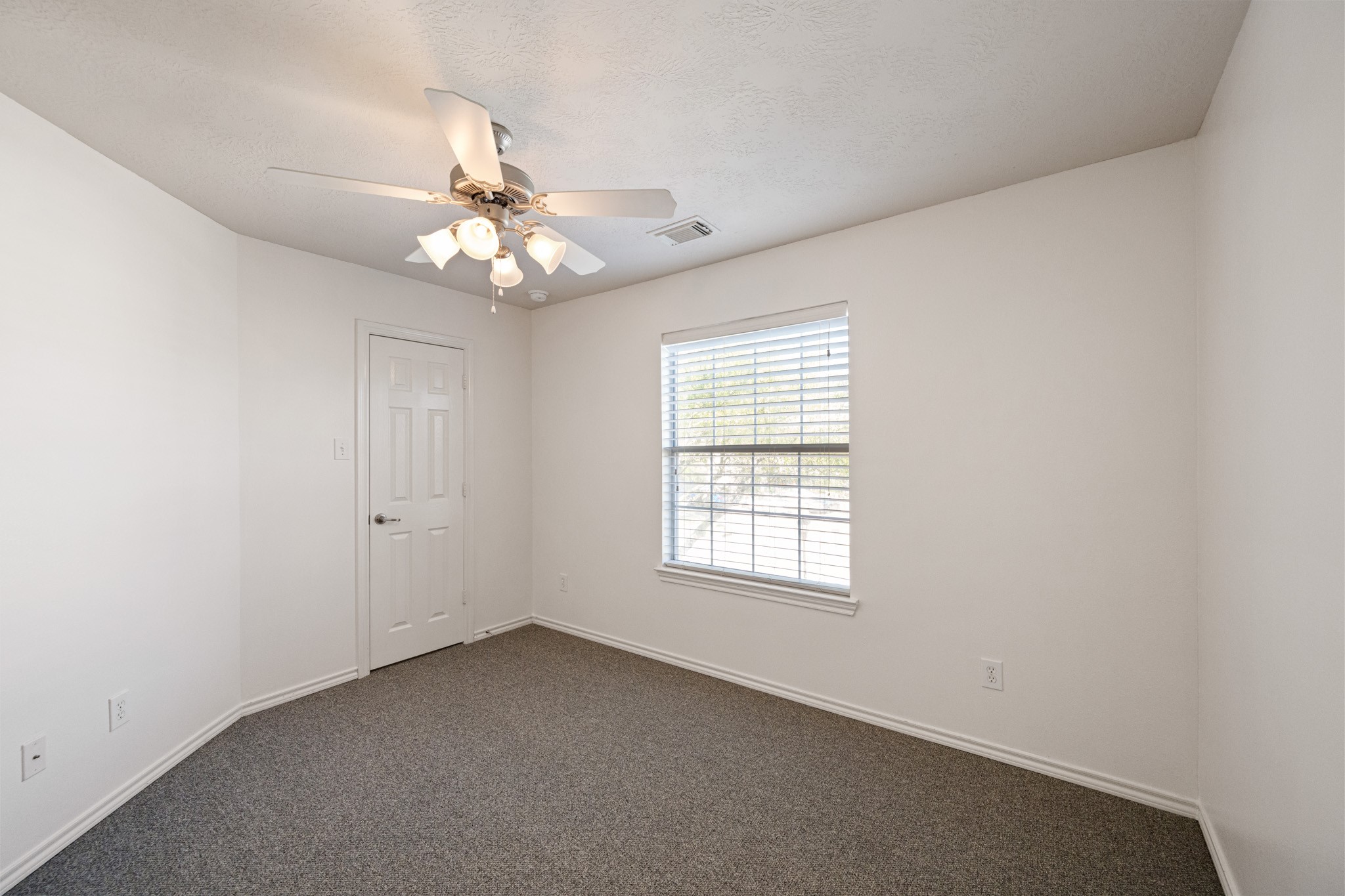 11938 Ramla Place Trail Houston, TX 77089 - Photo 25 of 28 Discover the inviting charm of bedroom 3, featuring soft carpet, a bright window, and a stylish ceiling fan for ultimate comfort.