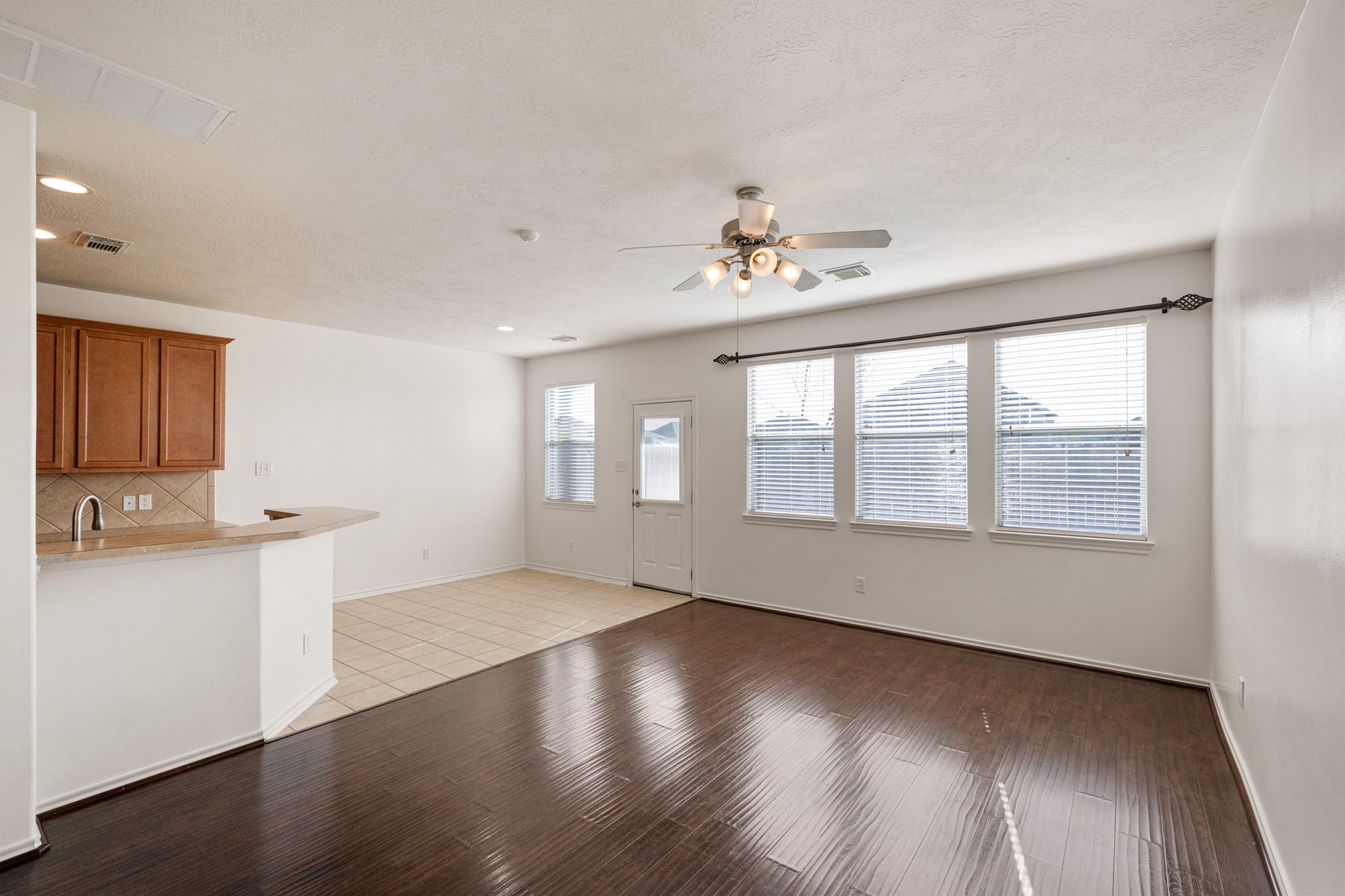 11938 Ramla Place Trail Houston, TX 77089 - Photo 4 of 28 This inviting living area features elegant flooring, abundant natural light from large windows, and a seamless flow into the kitchen, perfect for modern living and entertaining.
