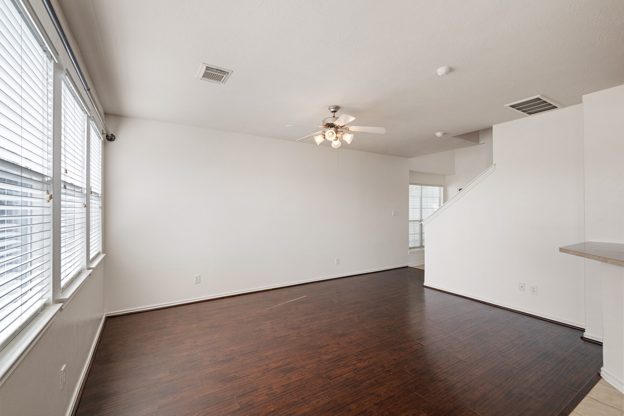 11938 Ramla Place Trail Houston, TX 77089 - Photo 5 of 28 Step into this inviting living area, where natural light floods through expansive windows, highlighting the sleek floors and creating a warm, welcoming ambiance perfect for relaxation and entertaining.