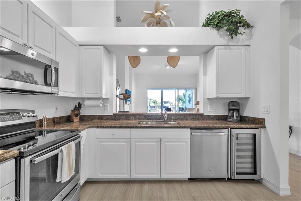 Undisclosed Address Naples, FL 34108 - Photo 11 of 44 a kitchen with stainless steel appliances granite countertop a sink and cabinets