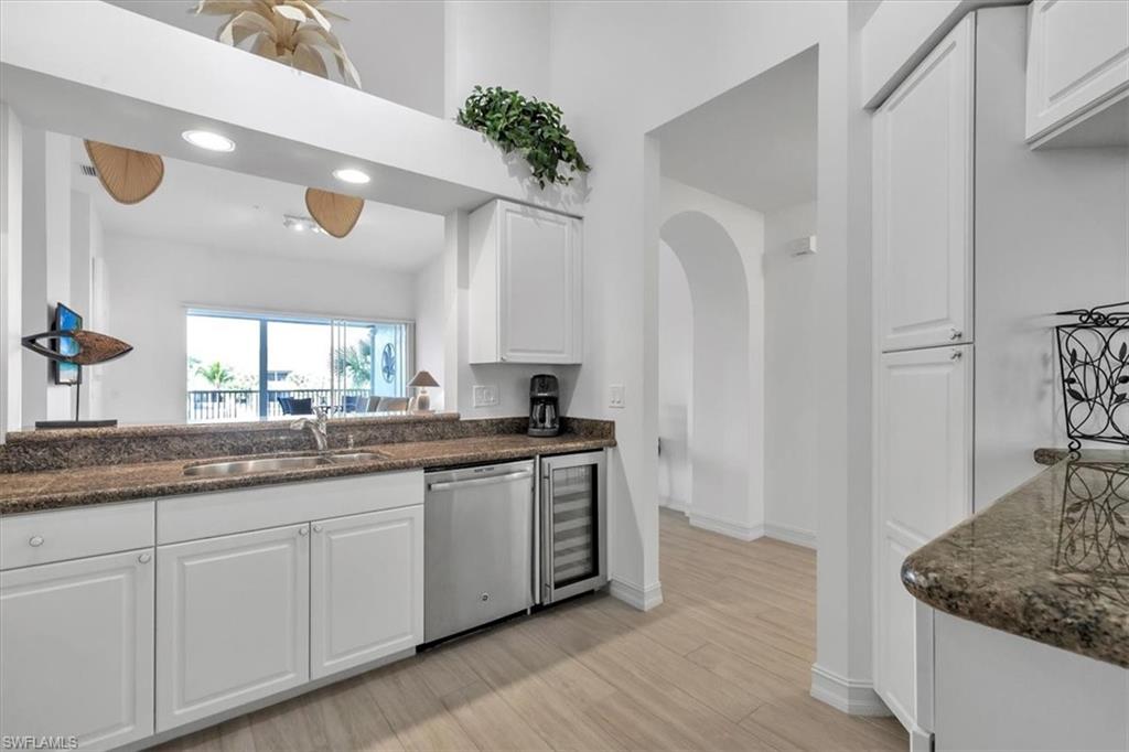 Undisclosed Address Naples, FL 34108 - Photo 12 of 44 a kitchen with a sink and cabinets