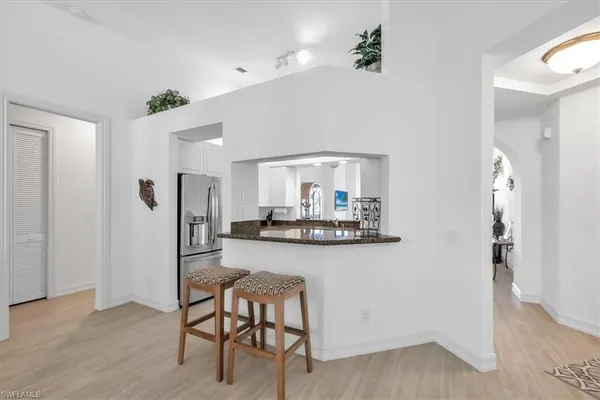a kitchen with stainless steel appliances granite countertop a refrigerator and a stove