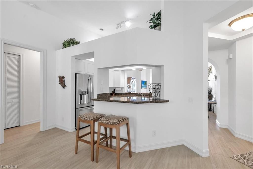 Undisclosed Address Naples, FL 34108 - Photo 14 of 44 a view of a kitchen from the hallway