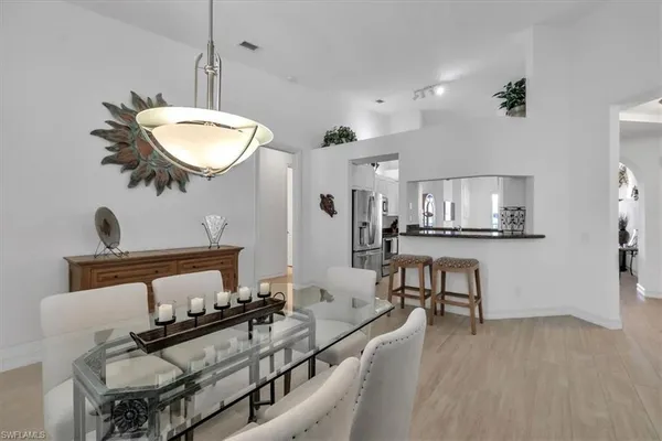 a dining room with furniture and window