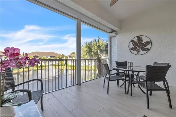 a view of a chairs and table in the balcony