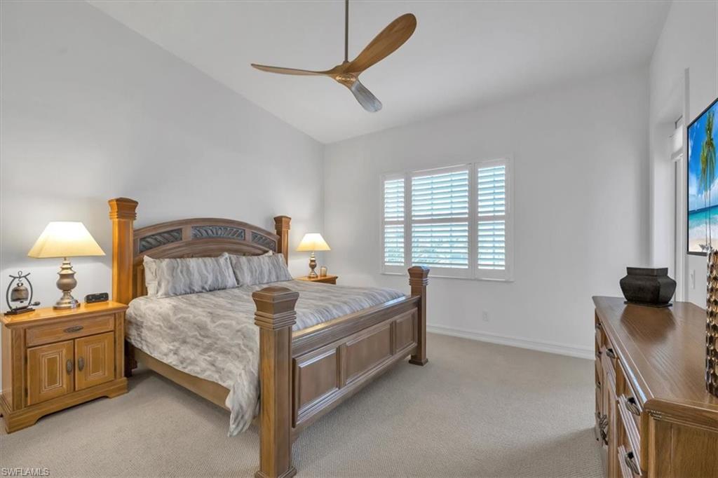 Undisclosed Address Naples, FL 34108 - Photo 22 of 44 a bedroom with a bed and a chandelier