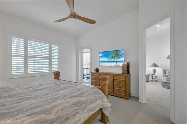 a bedroom with a bed a dresser and potted plants on a dresser