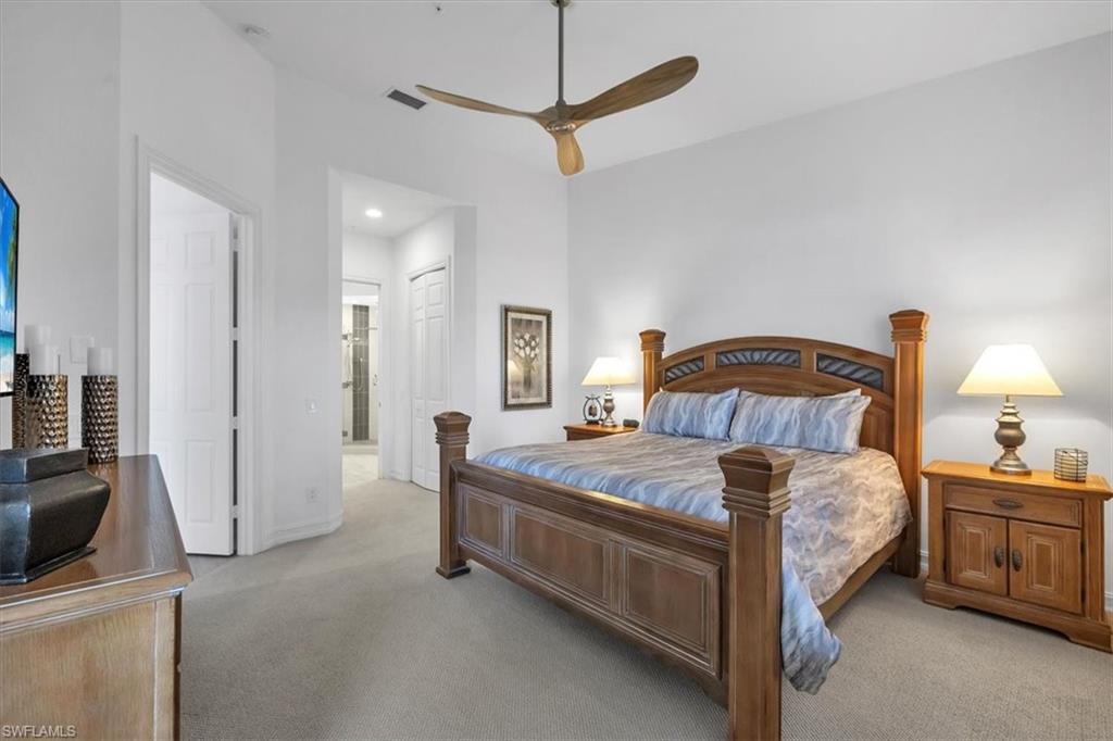 Undisclosed Address Naples, FL 34108 - Photo 24 of 44 a bedroom with a bed a dresser and potted plants on a dresser