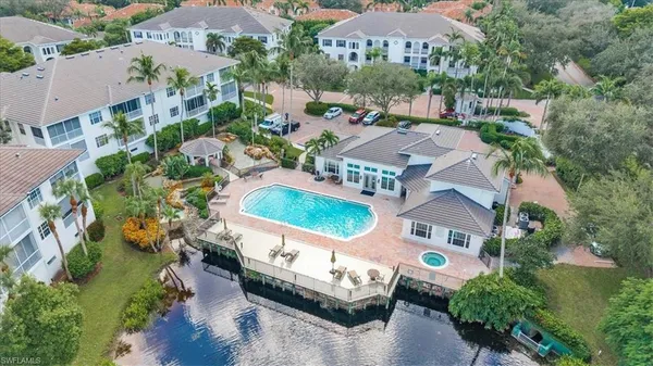 an aerial view of a house with yard swimming pool and outdoor seating