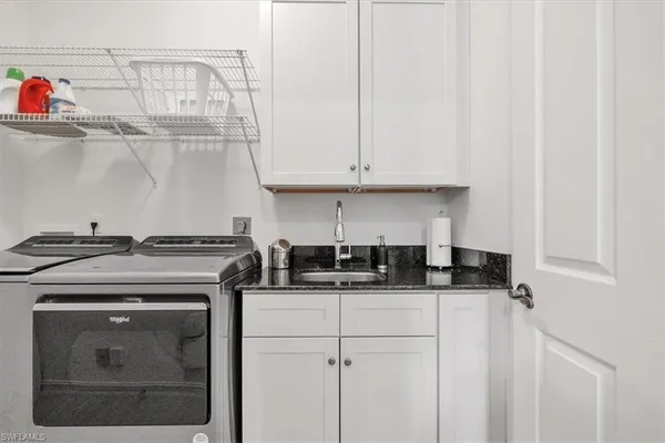 a kitchen with stainless steel appliances granite countertop a sink and cabinets