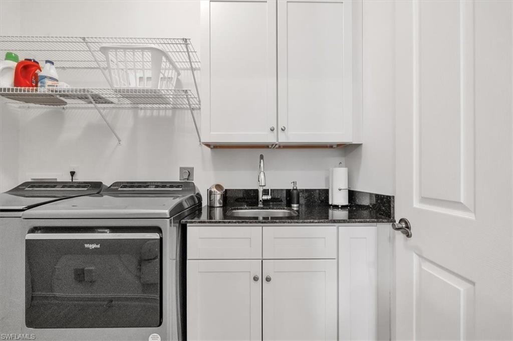 Undisclosed Address Naples, FL 34108 - Photo 31 of 44 a kitchen with stainless steel appliances granite countertop a sink stove and cabinets