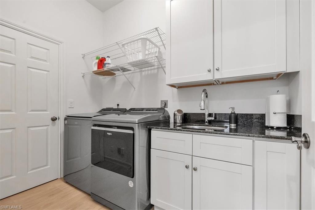 Undisclosed Address Naples, FL 34108 - Photo 32 of 44 a kitchen with stainless steel appliances granite countertop a sink and cabinets