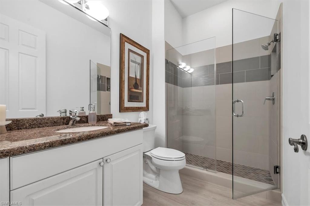 Undisclosed Address Naples, FL 34108 - Photo 38 of 44 a bathroom with a double vanity sink toilet and shower