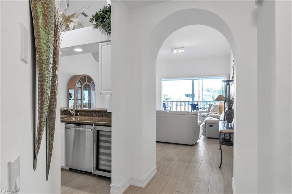 Undisclosed Address Naples, FL 34108 - Photo 6 of 44 a view of living room and kitchen with furniture