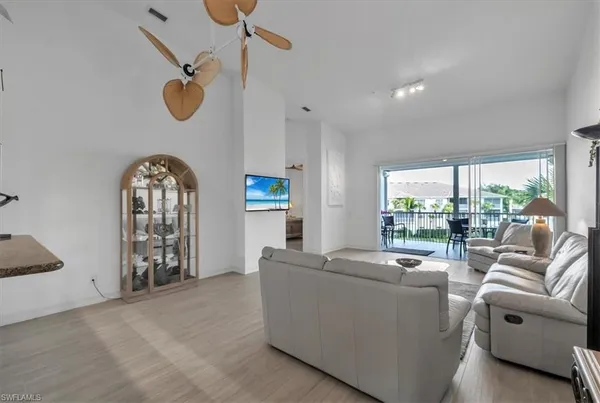 a living room with furniture a window and a chandelier