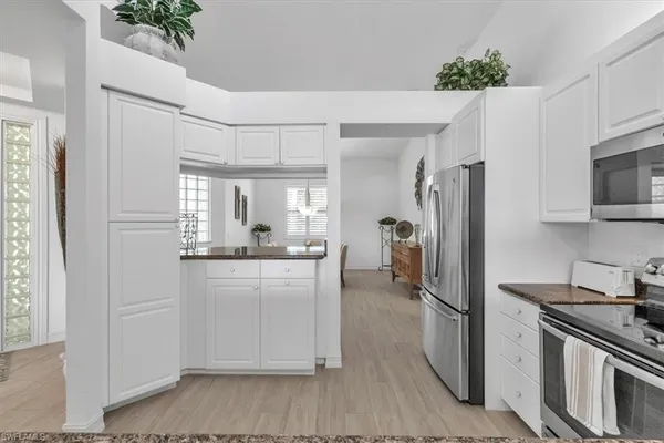 a kitchen with a refrigerator sink and stove