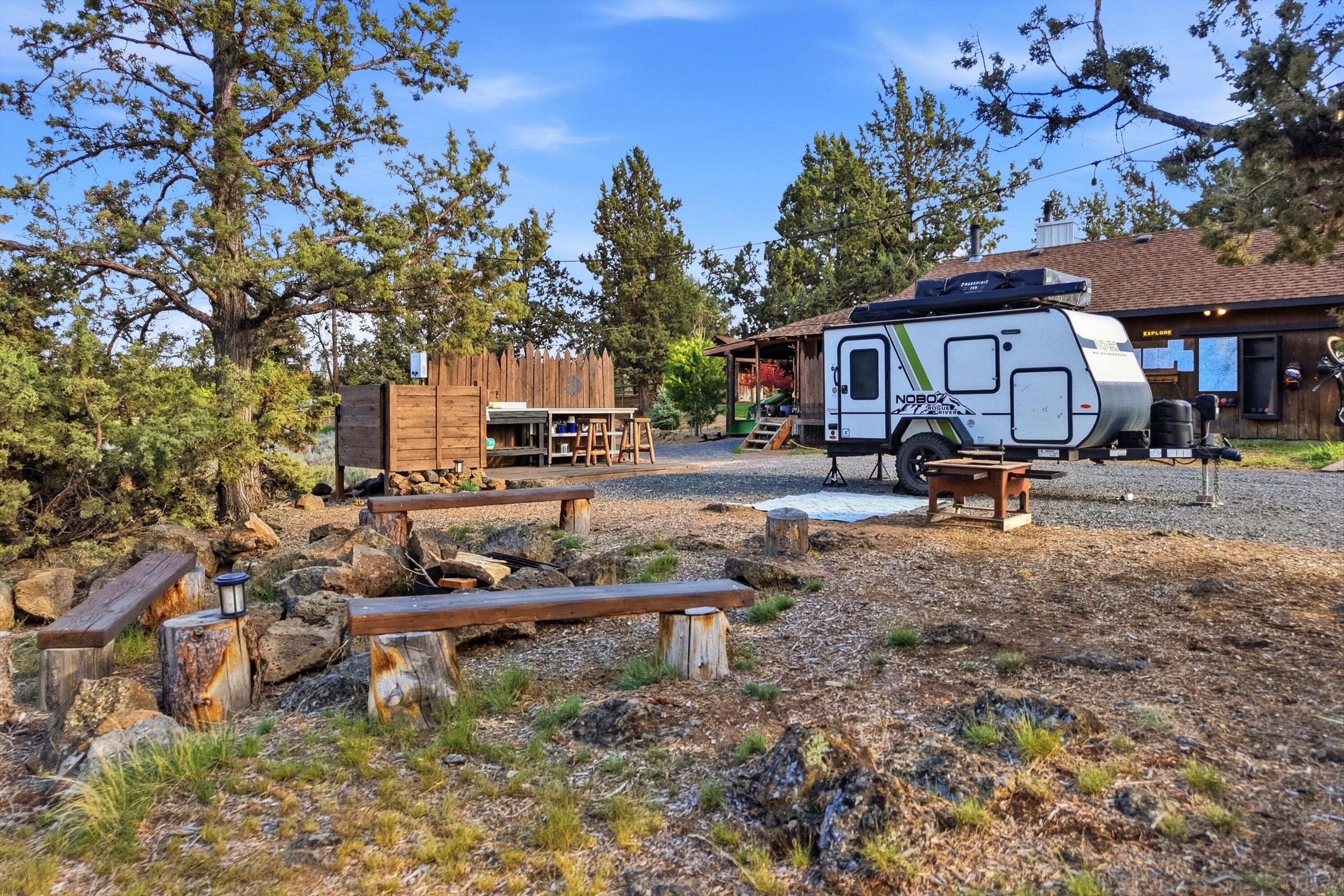 61280 Larsen Road Bend, OR 97702 - Photo 38 of 58 a backyard of a house with barbeque oven fire pit table and chairs