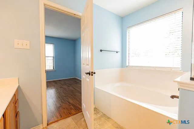 a bathroom with a bathtub and a shower