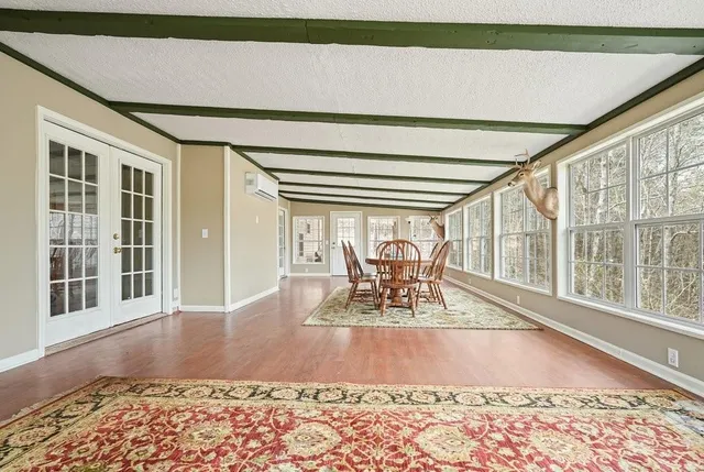 a room with furniture and a chandelier fan
