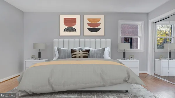 a bedroom with a large bed and a painting on the wall