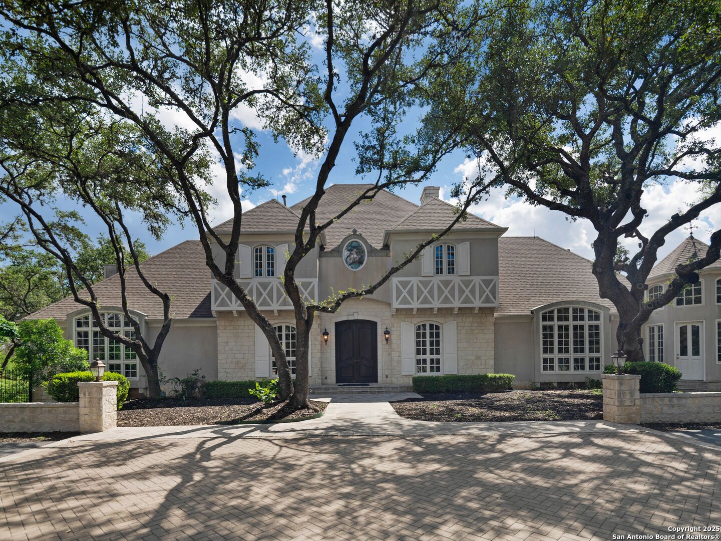 a front view of a house with a tree