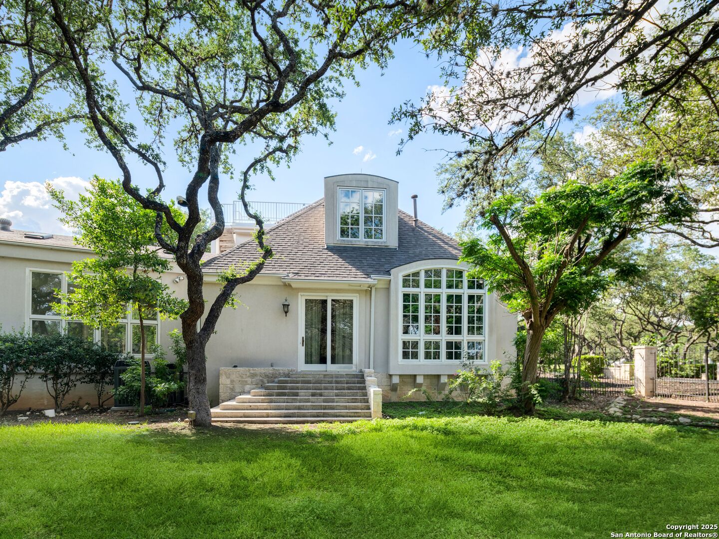 100 Tomahawk Trail Hill Country Village, TX 78232 - Photo 44 of 56 a front view of a house with a garden and trees