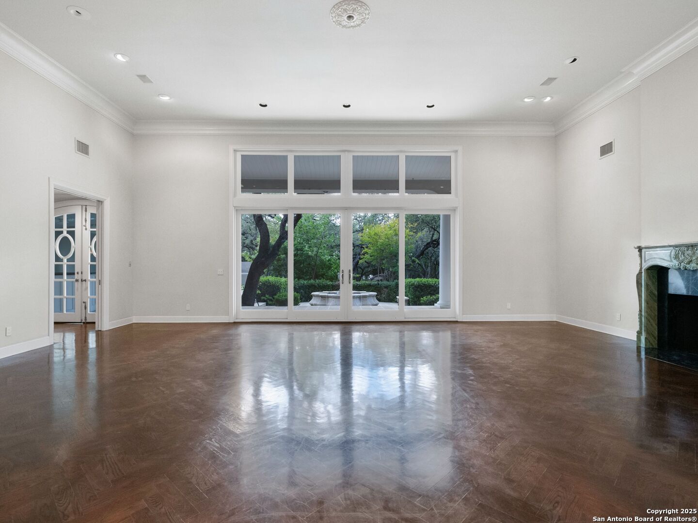 100 Tomahawk Trail Hill Country Village, TX 78232 - Photo 7 of 56 a view of an empty room with a window and wooden floor